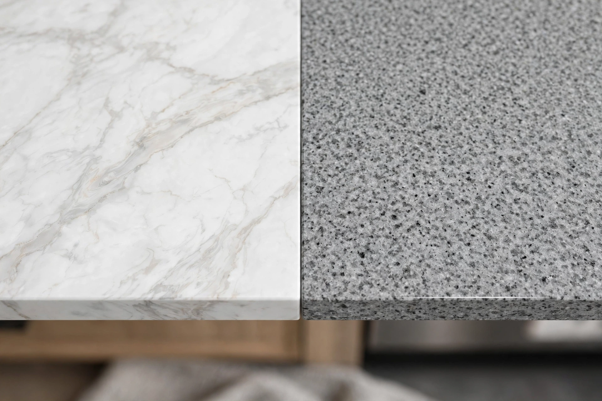 Side-by-side comparison of polished white quartzite and speckled gray granite countertop slabs